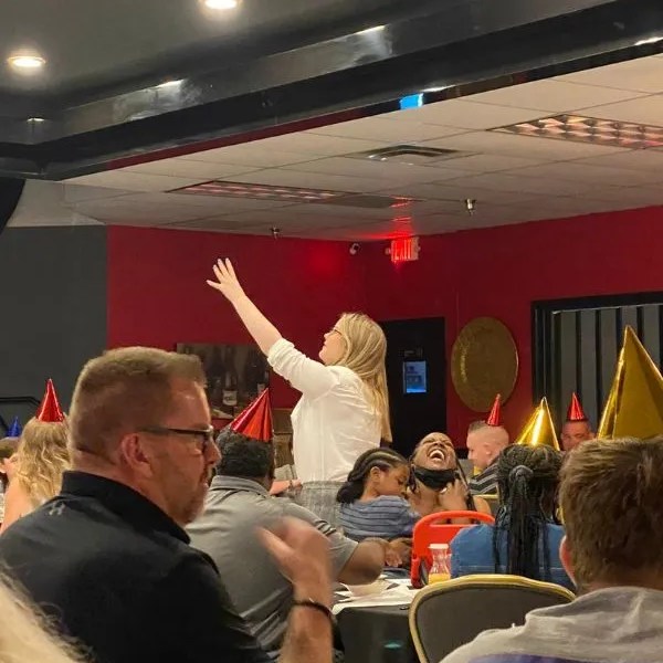 a woman standing with her hand in the air